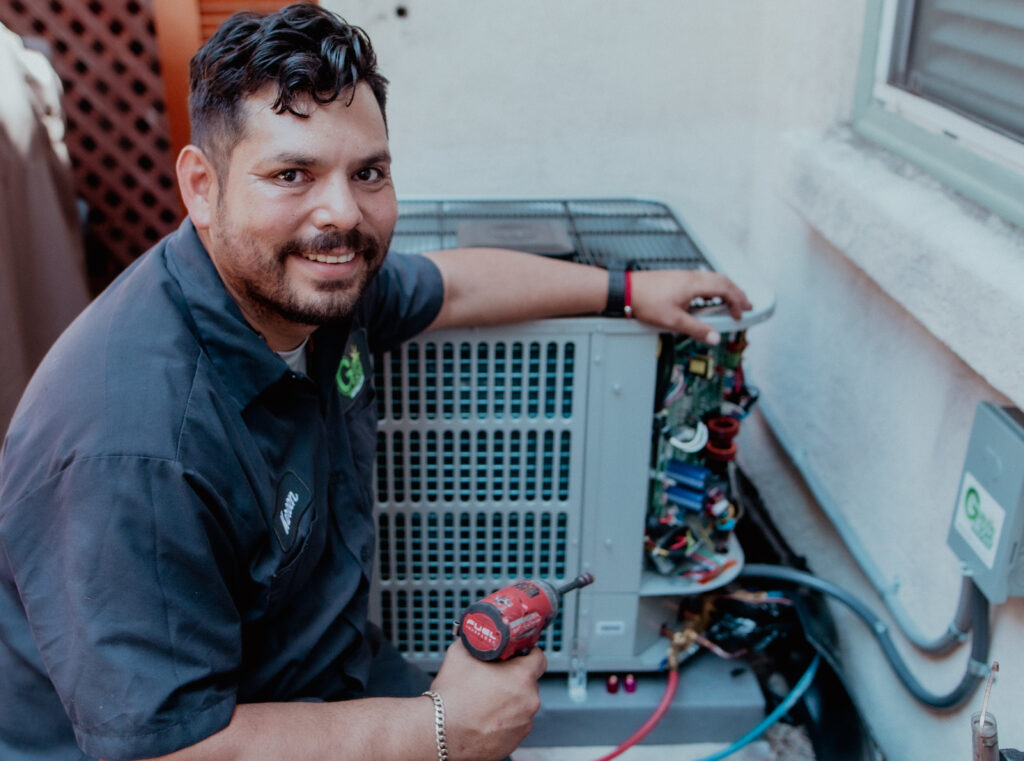 guthrie technician working on air conditioning unit
