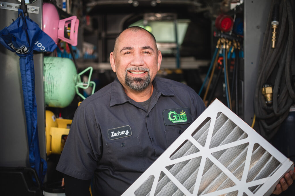guthrie technician holding a filter